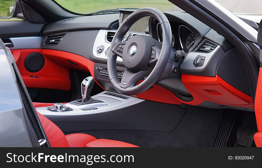 Black and red leather interior of BMW Z4 sports car outdoors on sunny day. Black and red leather interior of BMW Z4 sports car outdoors on sunny day.