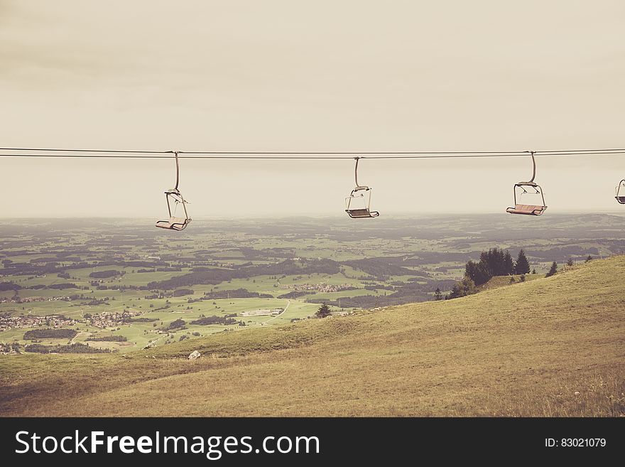 Empty Ski Lift Passing By Mountain During Daytime