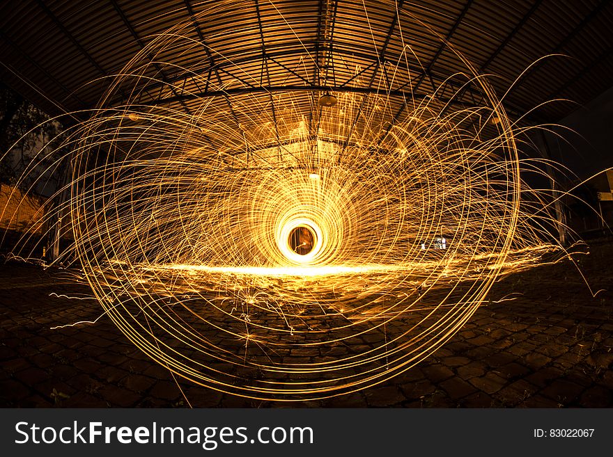 A long exposure of sparks flying from a spinning disk.