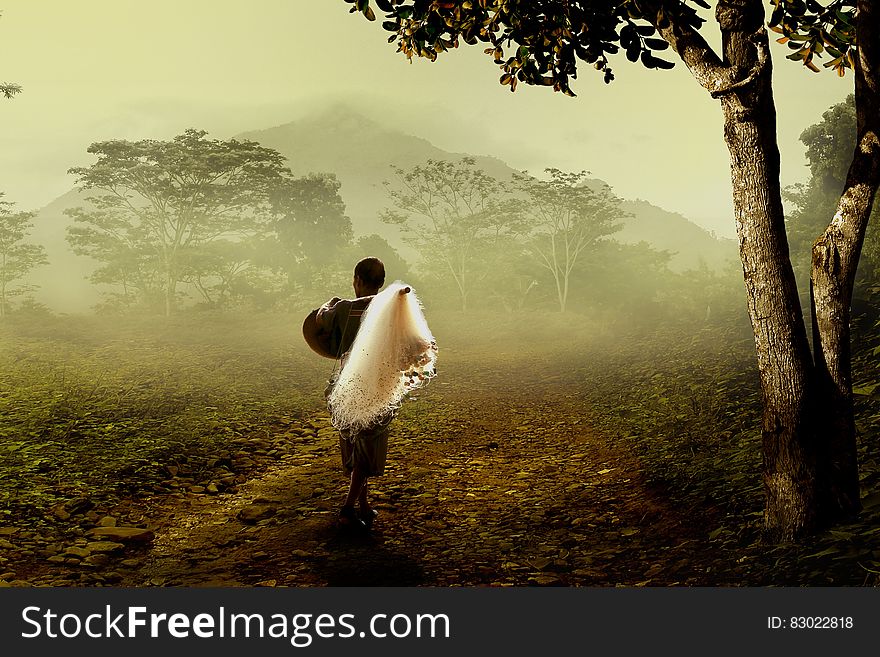 Man In Brown Robe Carrying White Fishing Net