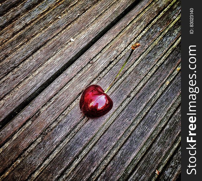 Red Cherry on Wooden Surface