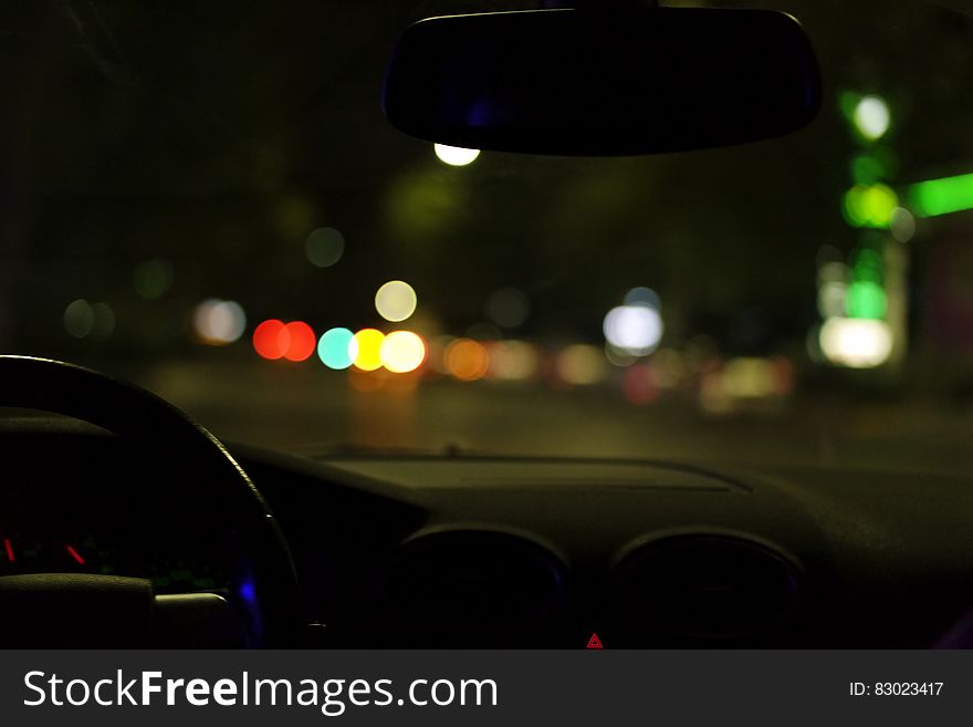 Bokeh of city lights through car window at night. Bokeh of city lights through car window at night.