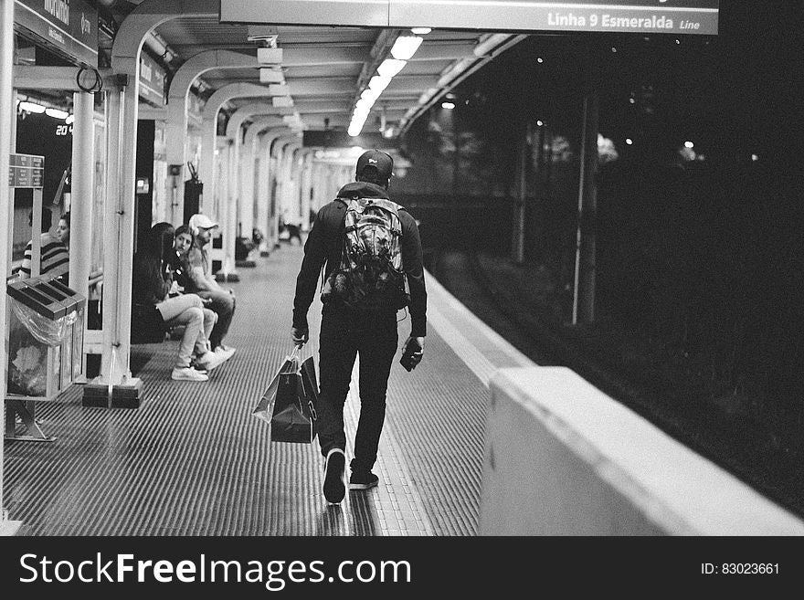 Man walking on subway platform in black and white. Man walking on subway platform in black and white.