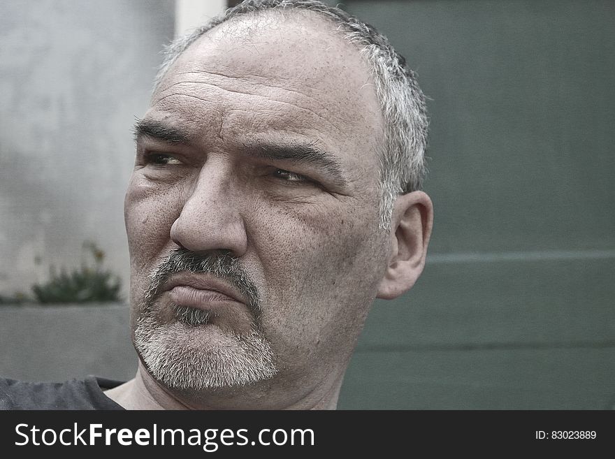 Man In Black Shirt Near Gray Wall