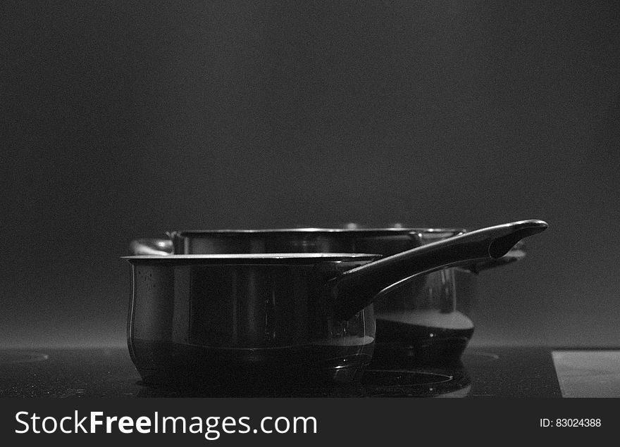 Close up of pots on electric stove in black and white. Close up of pots on electric stove in black and white.