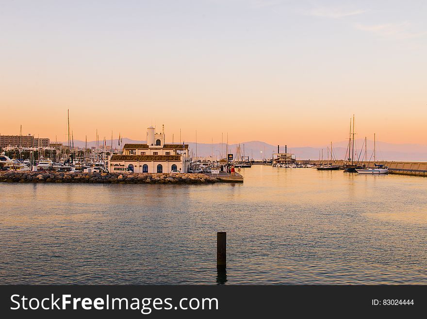 Boats In Marina At Sunset