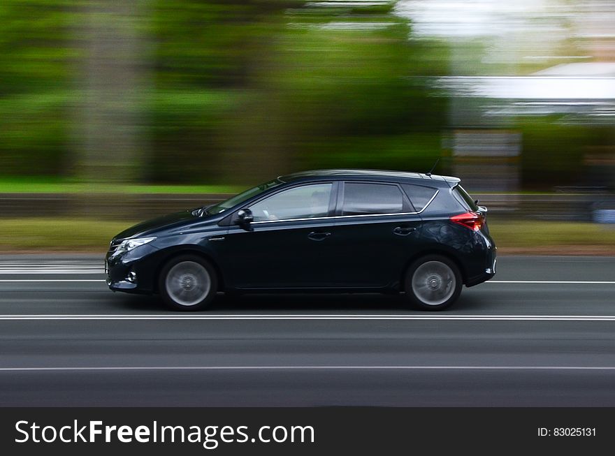 Car driving on sunny road with blur of landscape in daytime. Car driving on sunny road with blur of landscape in daytime.