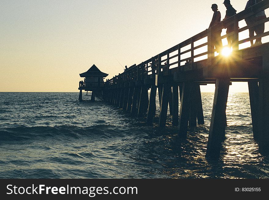 3 Person Standing on Pier