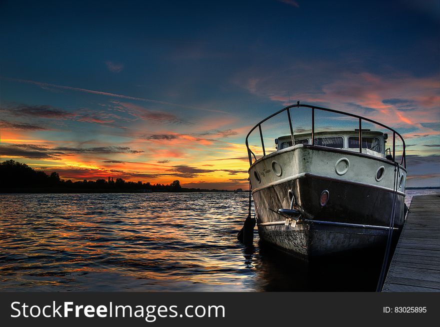 Boat In Water At Sunset