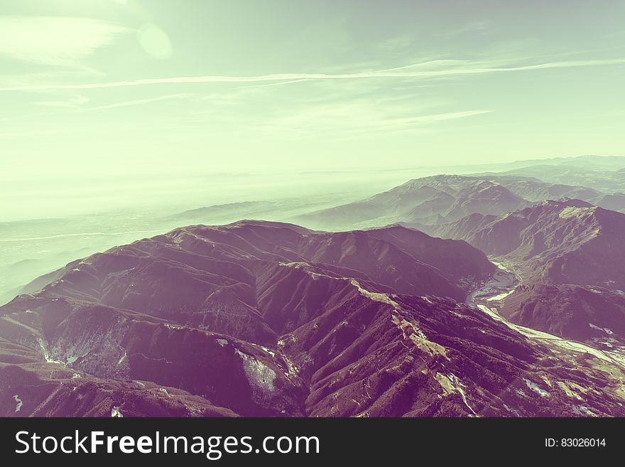 Mountains during Daytime and White Cloudy Sky