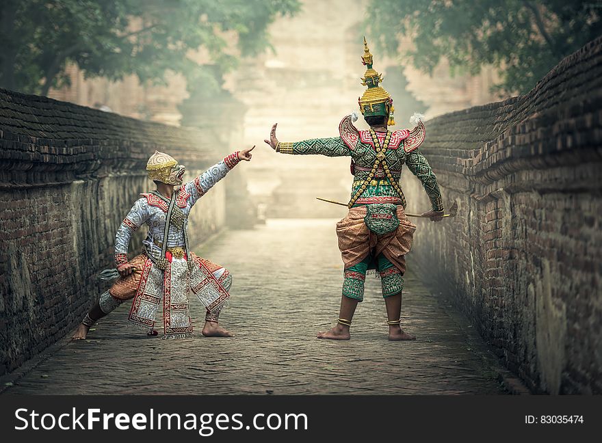 Asian actors dressed as ancient warriors on stone bridge on sunny day. Asian actors dressed as ancient warriors on stone bridge on sunny day.