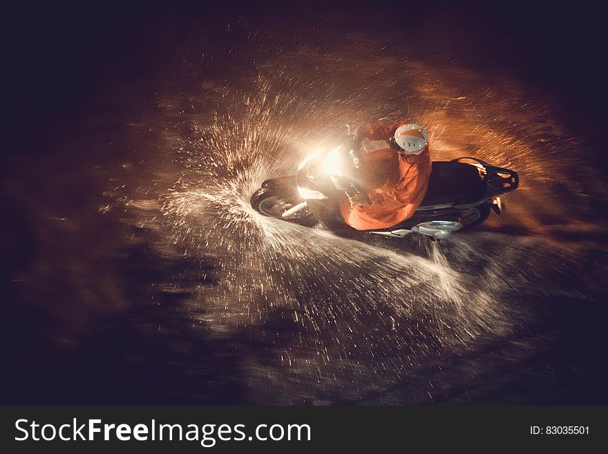 Motorcycle rider driving through water with headlight in dark. Motorcycle rider driving through water with headlight in dark.