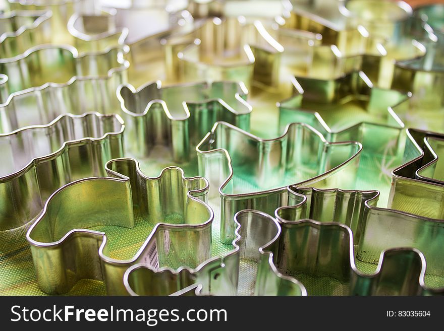 Close up of metal animal shaped cookie cutters on kitchen counter.