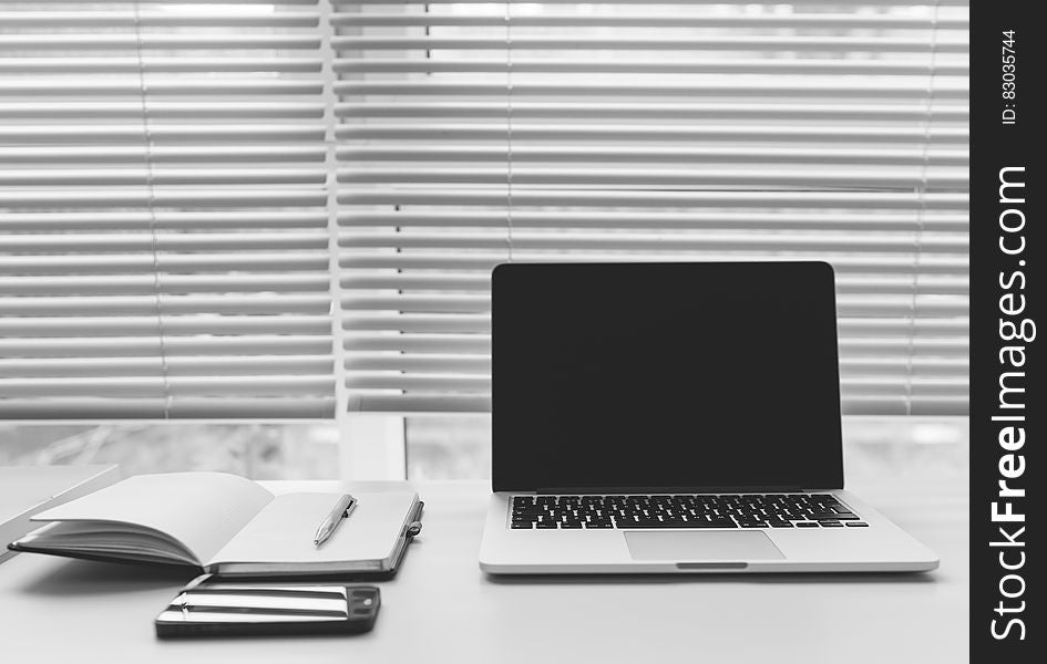 Laptop And Notebooks On Desk