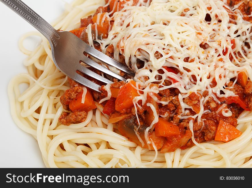 A portion of ragu sauce spaghetti with grated cheese on top.