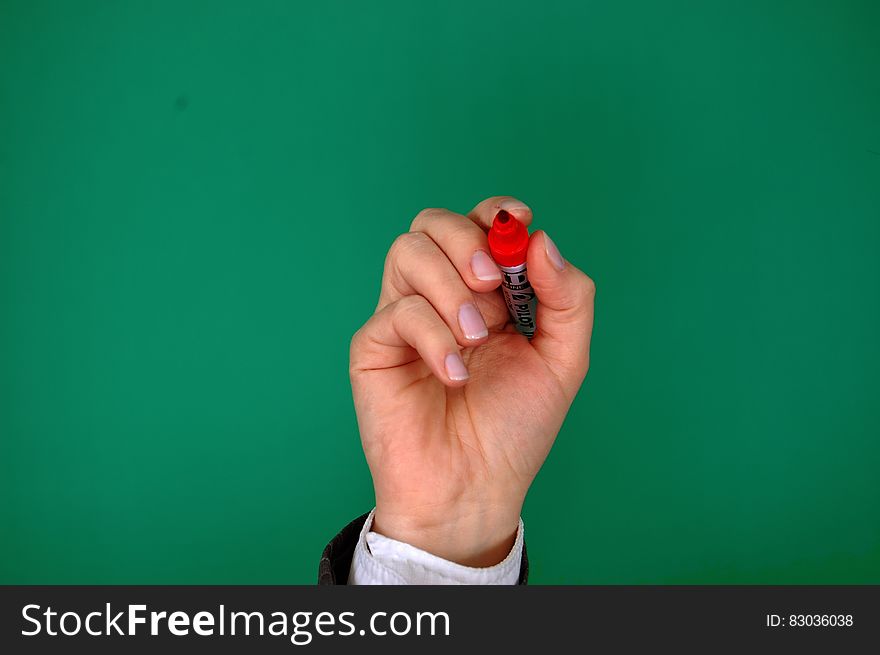 Person Holding Red Marker