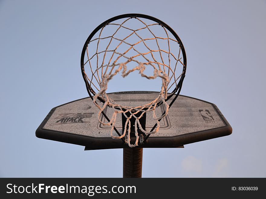 A basketball backboard with a basket attached to it. A basketball backboard with a basket attached to it.