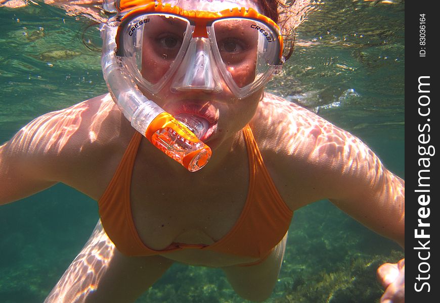 Woman in Orange Bikini Underwater With Snorkel