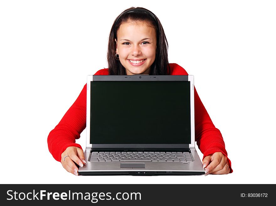 A young woman holding a laptop computer. A young woman holding a laptop computer.