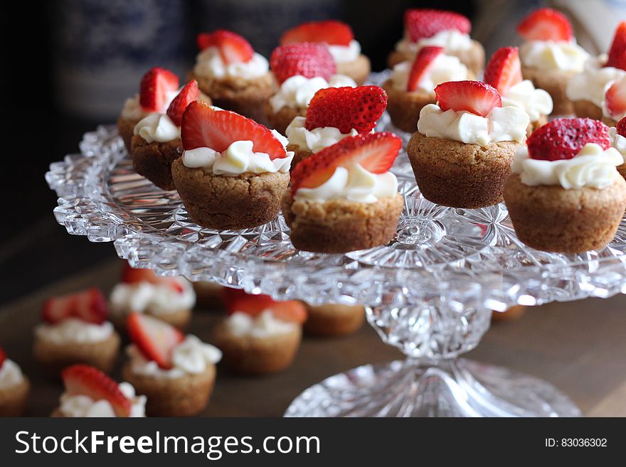 Cupcake With Strawberry Toppings on Clear Glass Cup Cake Rack