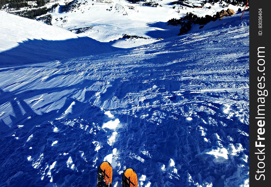 A downhill skier on the slope with the point of view of the skier. A downhill skier on the slope with the point of view of the skier.