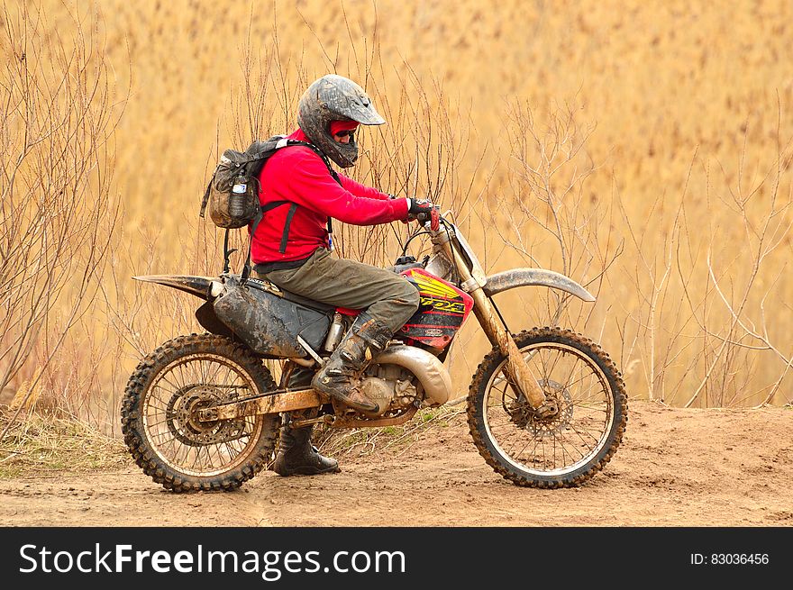 Man in Red Sweater Driving Dirt Bike