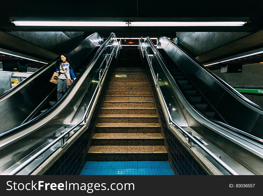 Woman on Escalator in Subway