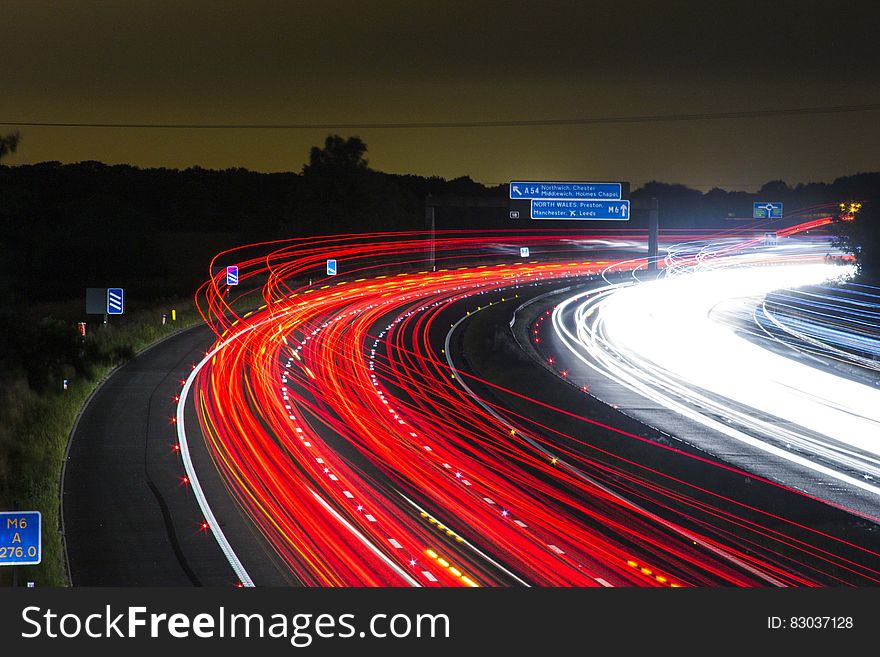 Time Lapse Photography of Car Passing by the Winding Road during Nighttime