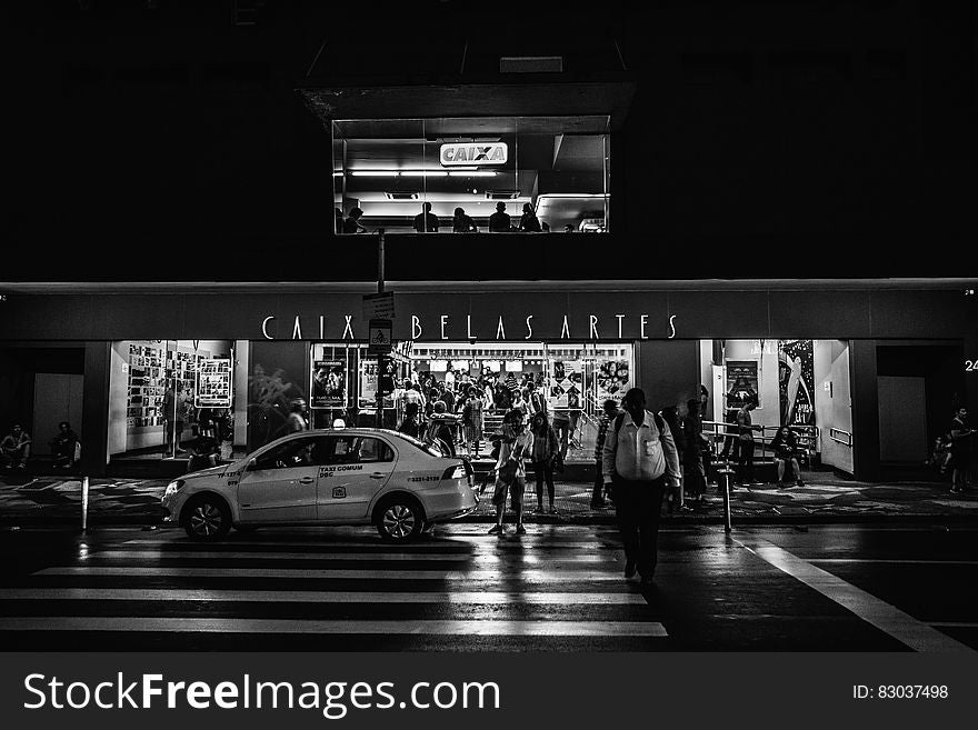 Car Parked On The Street In Grayscale