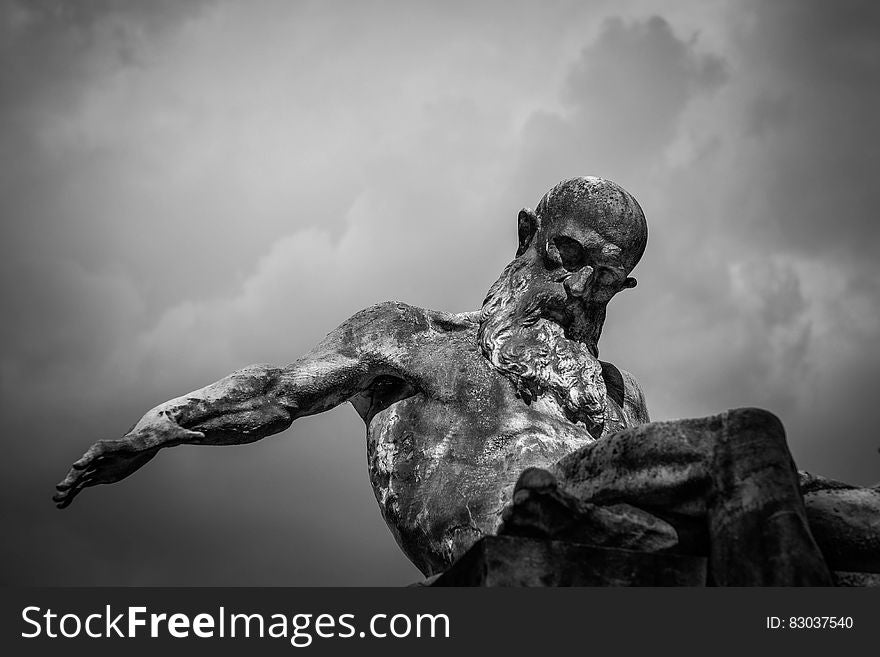 Grayscale Photo of Gray Man Statue