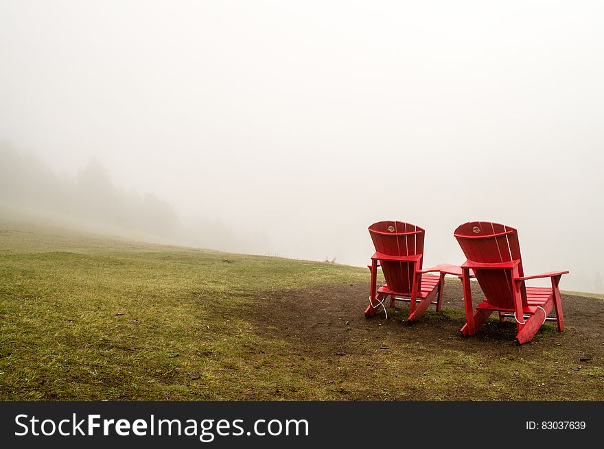 Brown Wooden Beach Lounge Chair on Brown and Green Grass Field