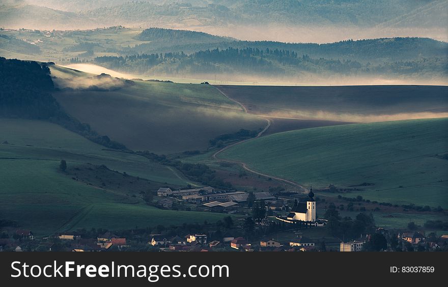 Village In Valley At Sunset