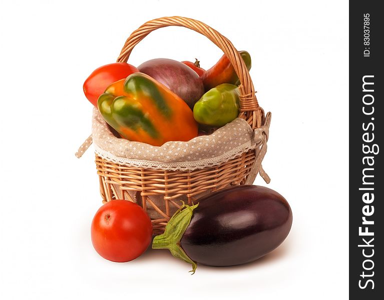 Wicker basket with fresh vegetables on white. Wicker basket with fresh vegetables on white.