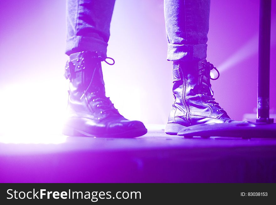 Person Wearing Lace Up Boots Standing on Stage