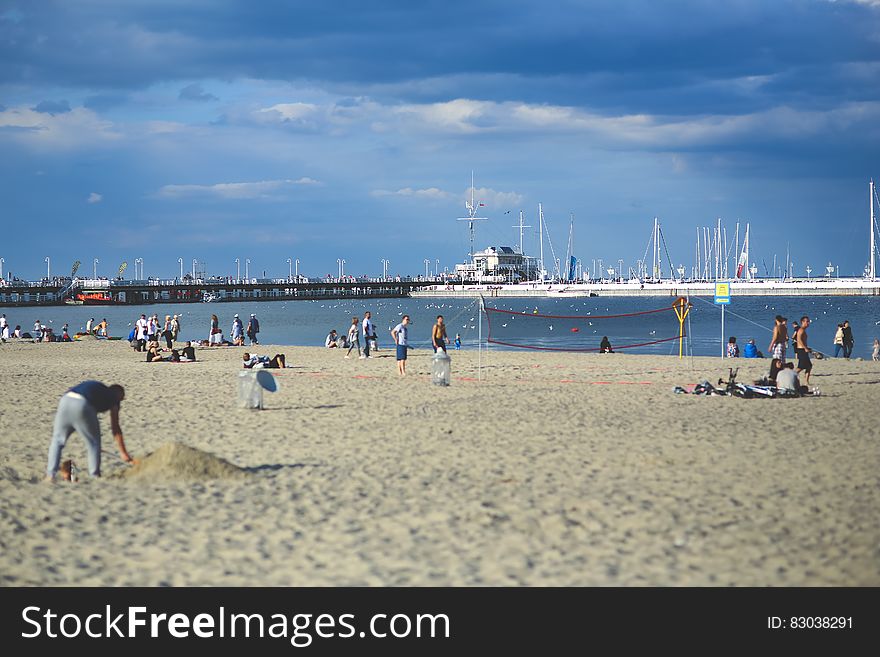 People on the beach. Pier & marina
