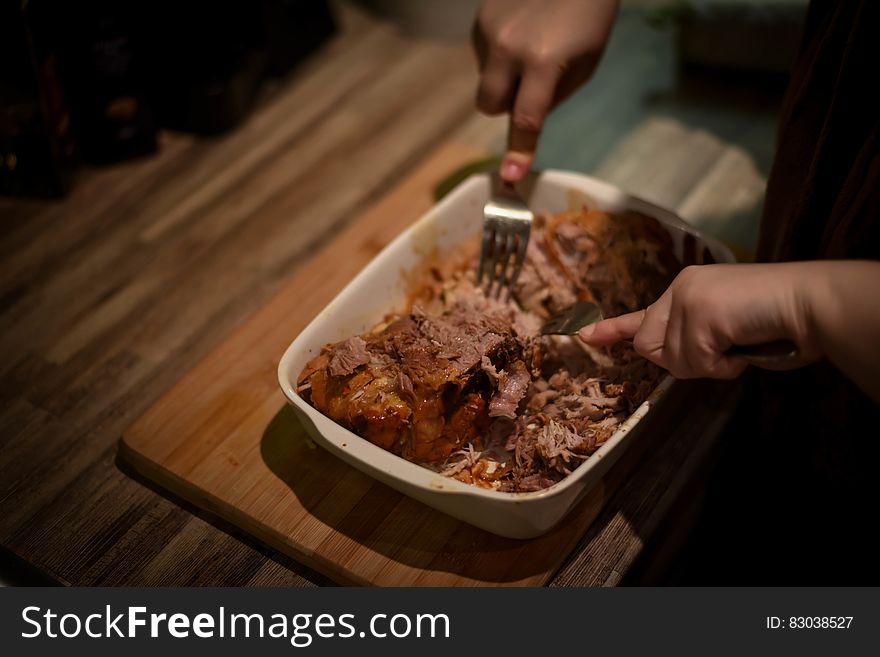 Person Mixing Cook Meat on White Food Container