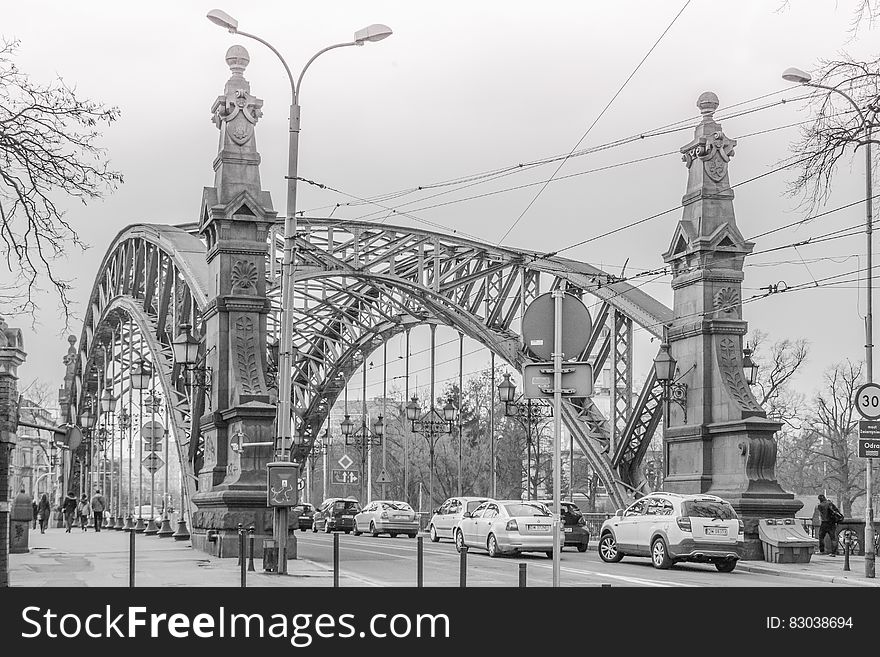 Greyscale Photo of a Bridge With Cars Being Caught in a Traffic during a Snow Weather