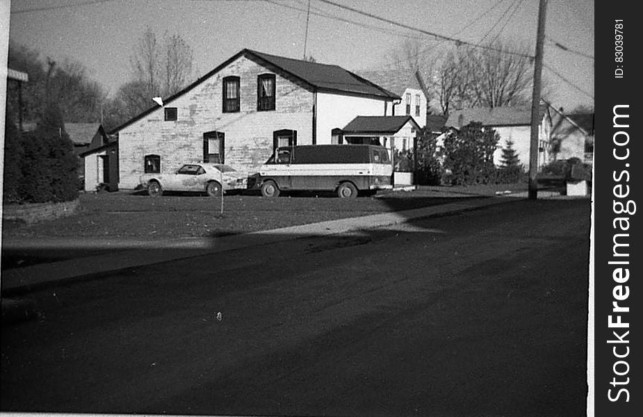 Car and van parked outside home in Belleville circa 1970 in black and white. Car and van parked outside home in Belleville circa 1970 in black and white.