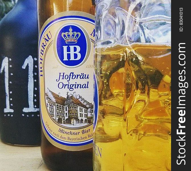 Bottle of Hofbrau Original beer next to glassware.