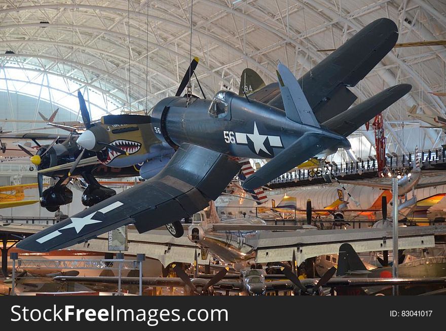 Vintage fighter jets suspended from ceiling of museum hall. Vintage fighter jets suspended from ceiling of museum hall.