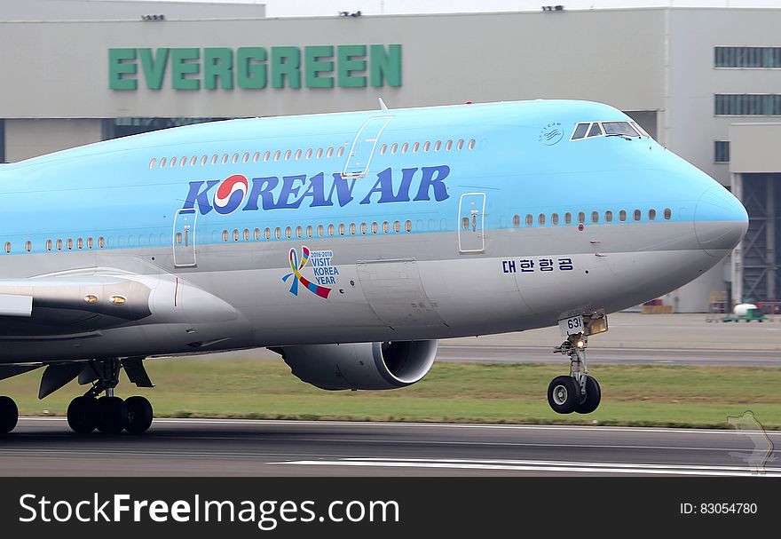 Korean jumbo jet landing on runway at international airport. Korean jumbo jet landing on runway at international airport.