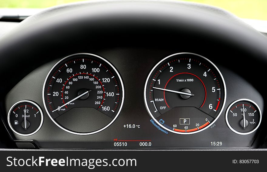 Dials and gauges on leather dashboard of luxury car. Dials and gauges on leather dashboard of luxury car.