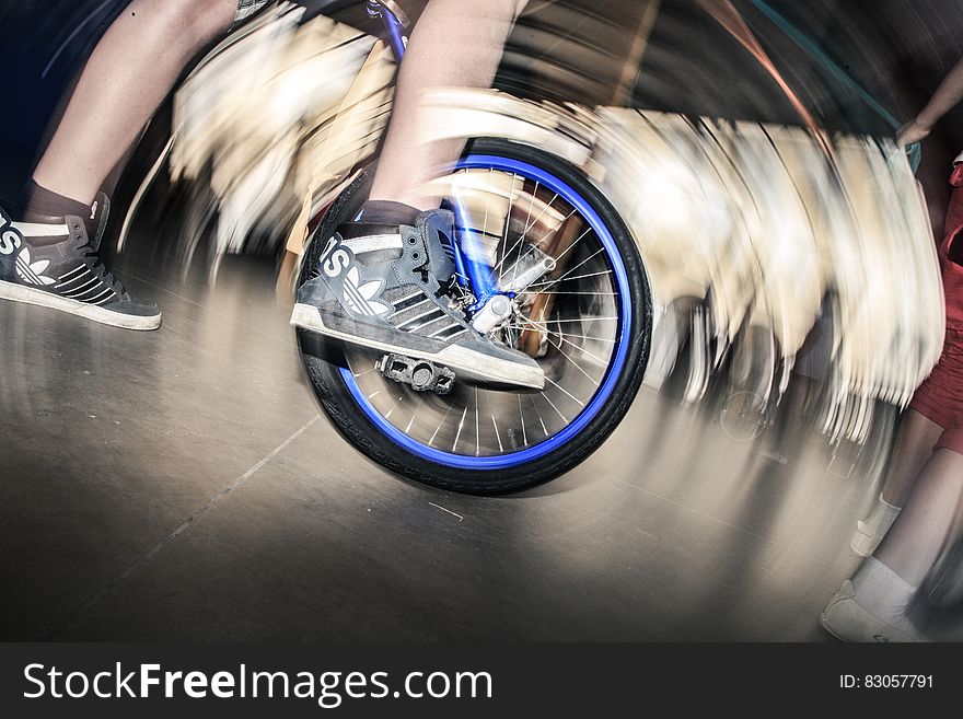 A person on an unicycle. A person on an unicycle.