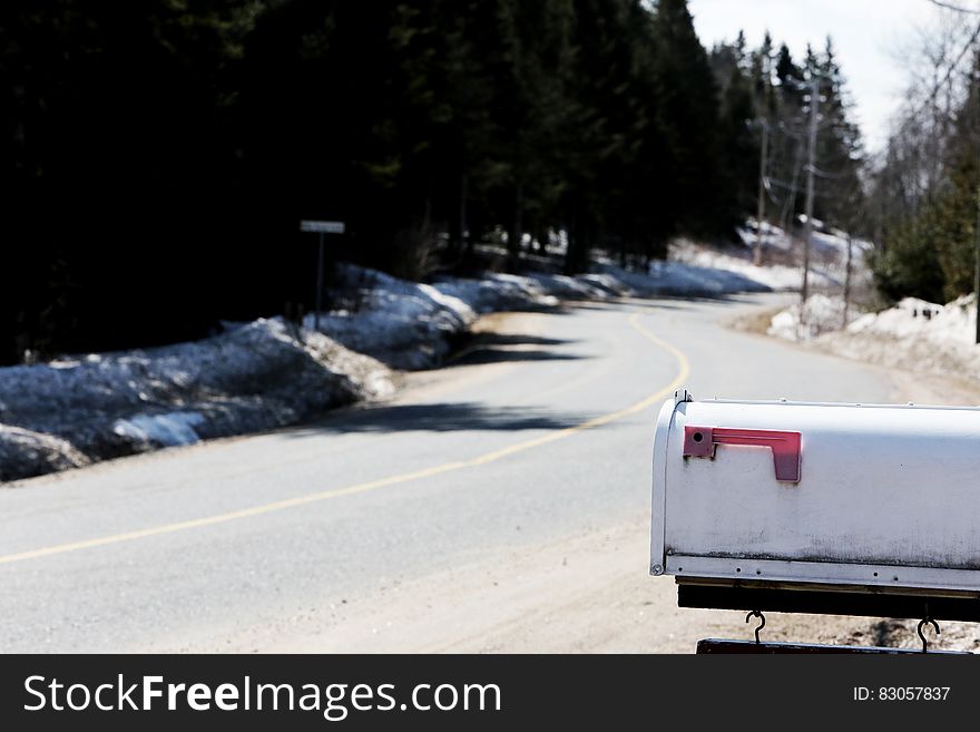 White Metal Mailbox Near Grey Asphalt Road at Day Time