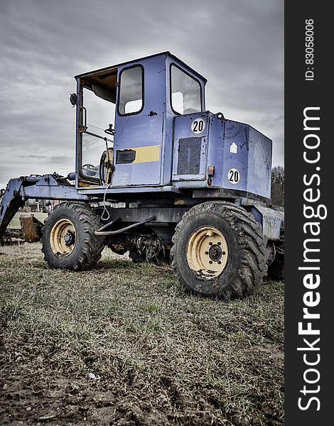 Blue and Black Tractor in Green Grass