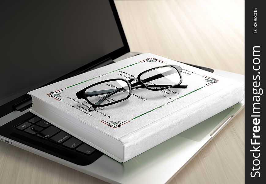 Black Frame Eyeglasses on White Book