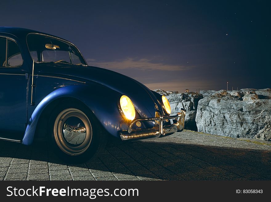 Blue Volkswagen Beetle Car Near Cliff during Night Time
