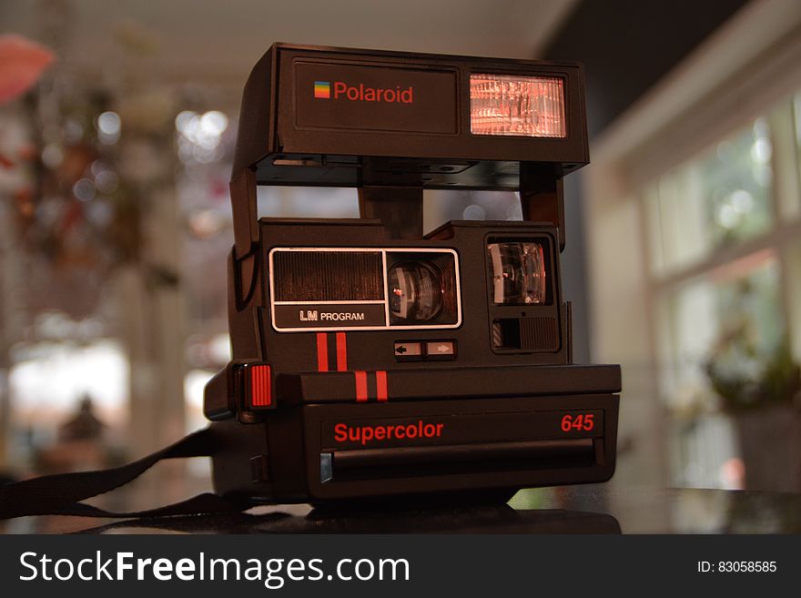 Black Polaroid Supercolor Camera on Black Table