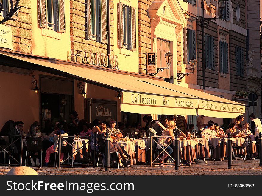 People Sitting Outside Caffetteria during Daytime