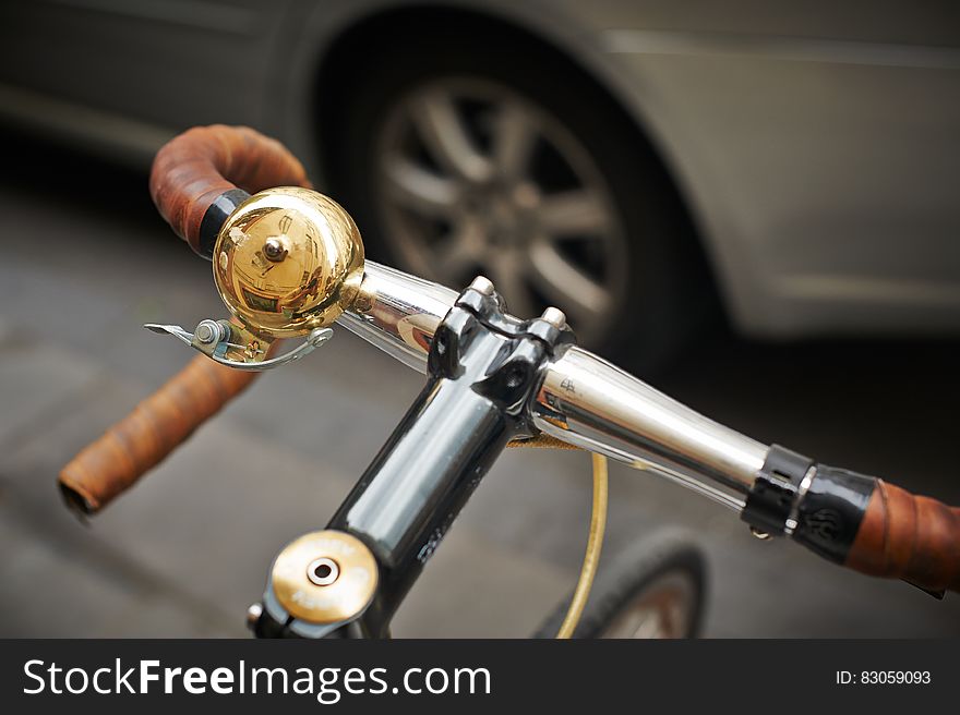 Close up of bell on bicycle handlebar on streets.